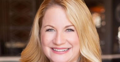 Headshot of blonde haired lady smiling
